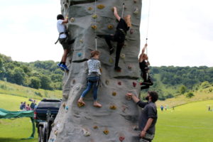Young people on rock climbing tower