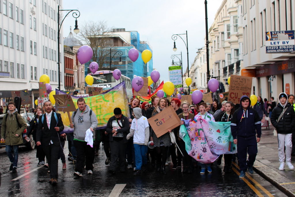 Young people march together at a peaceful demonstration against youth work cuts in Brighton. January 2017